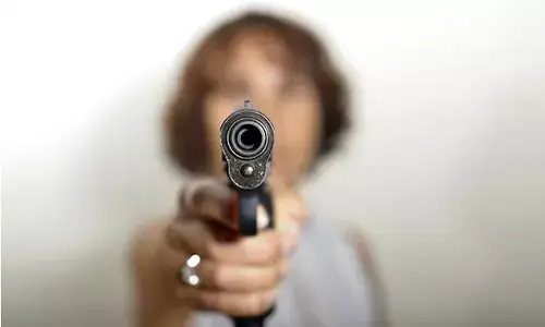 Photo of  A woman with gun