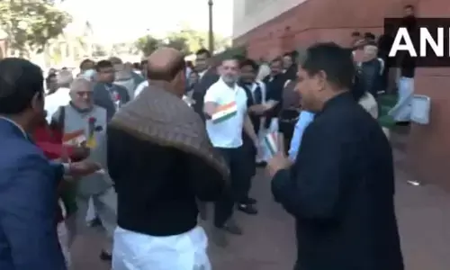Photo of Rahul Gandhi giving rose flower to Rajnath Singh