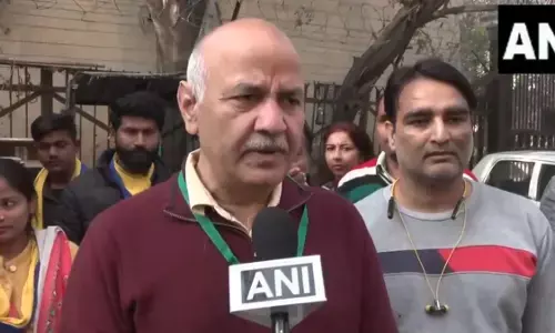 AAP leader Manish Sissodia addressing media persons, outside of a Polling station during Delhi general assembly elections on Wednesday