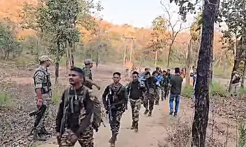Security personnel at the encounter sit at Bijapur-Dantewada border, Chhattisgarh