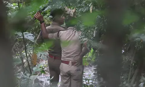 Police team conducting an inquest of the mortal remains recovered from a forested area in Kalamassery